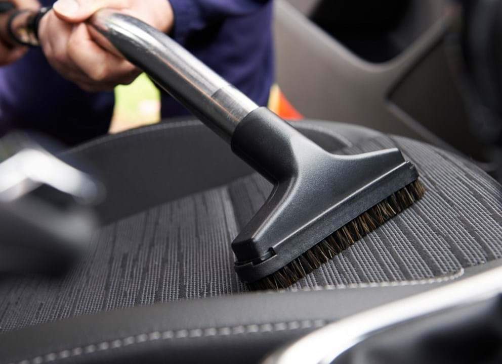 how-to remove cigarette smell from your car - turtle wax - vacuum car upholstery