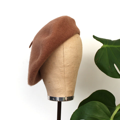 A Camel coloured wool beret shown on a mannequin head