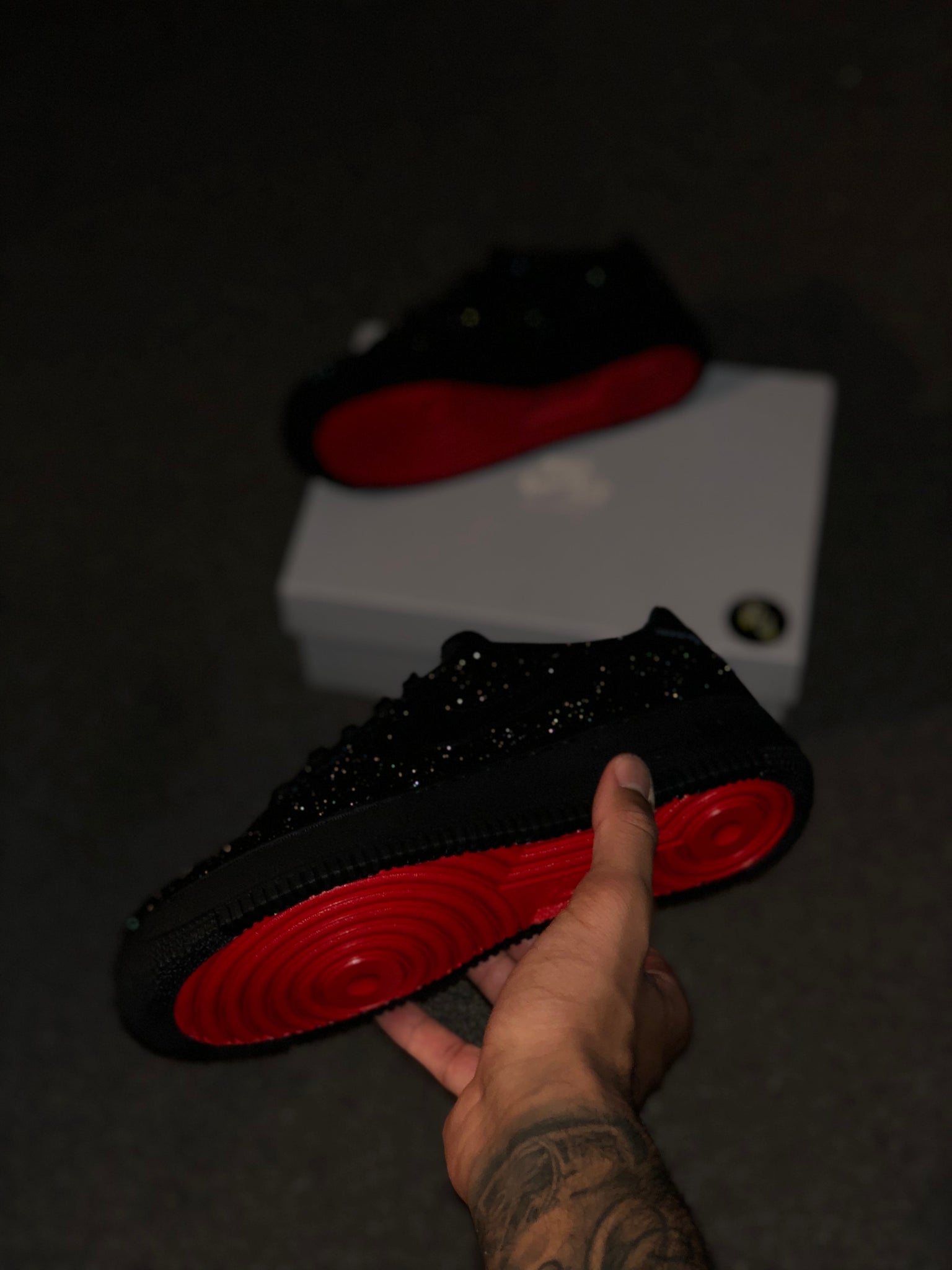 black nike with red bottoms