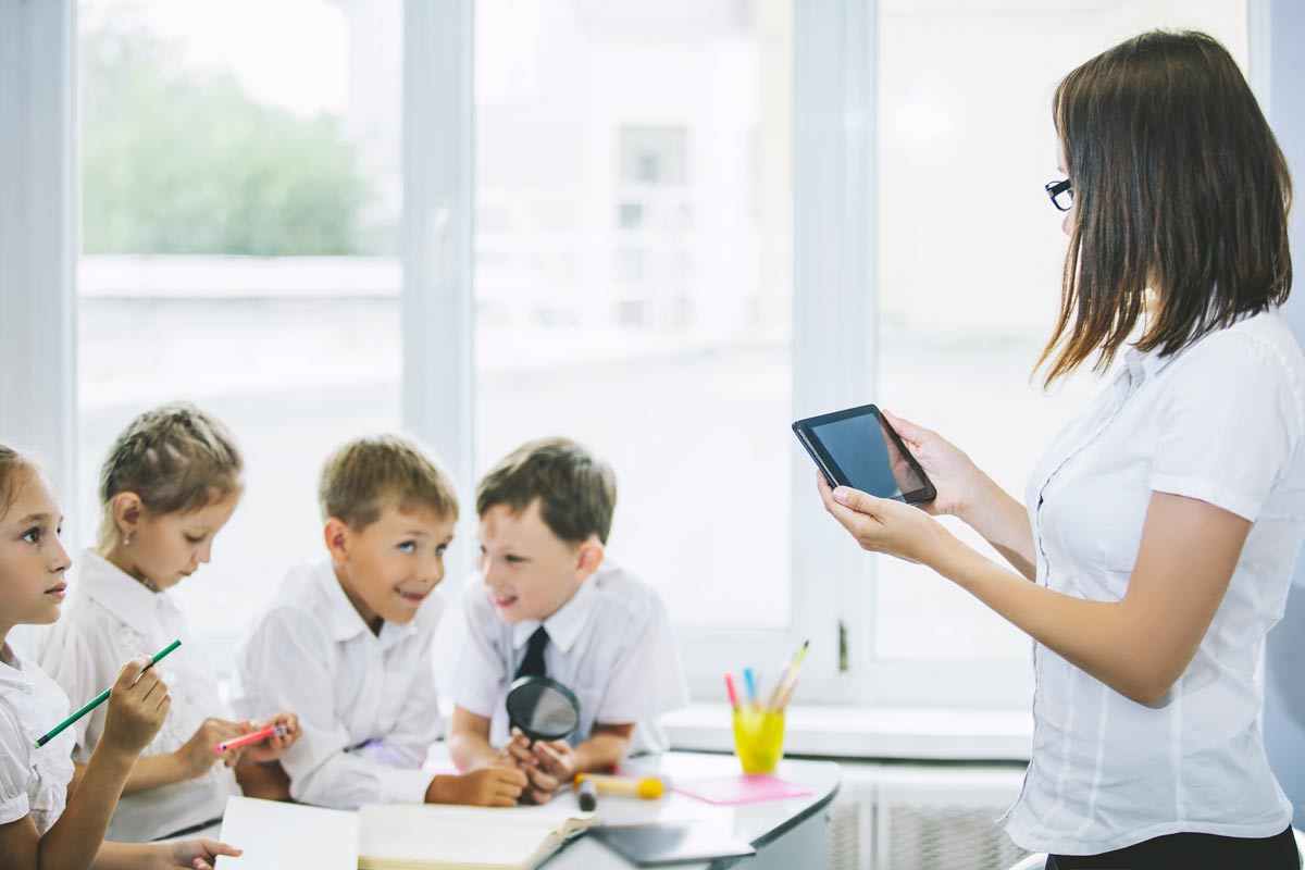 image of a female teacher using technology in the classroom