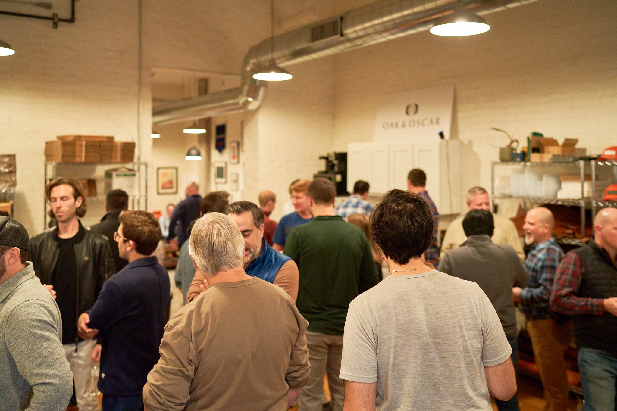 People gathered in a room talking and drinking