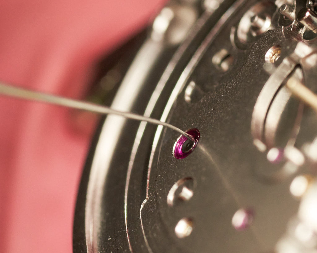 In house watchmaker lubricating and reassembling an Oak & Oscar watch