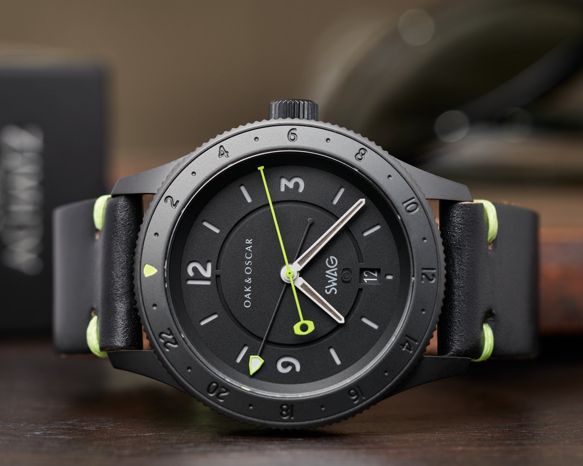 Image of dark black watch with green seconds hand