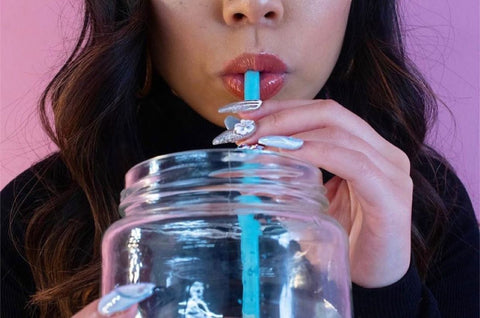 girl sipping from WonderSip Straw inside clear cup 