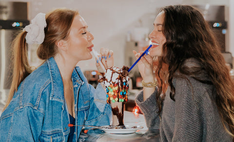 Friends sharing an ice cream sunday using 2 wondersip straws