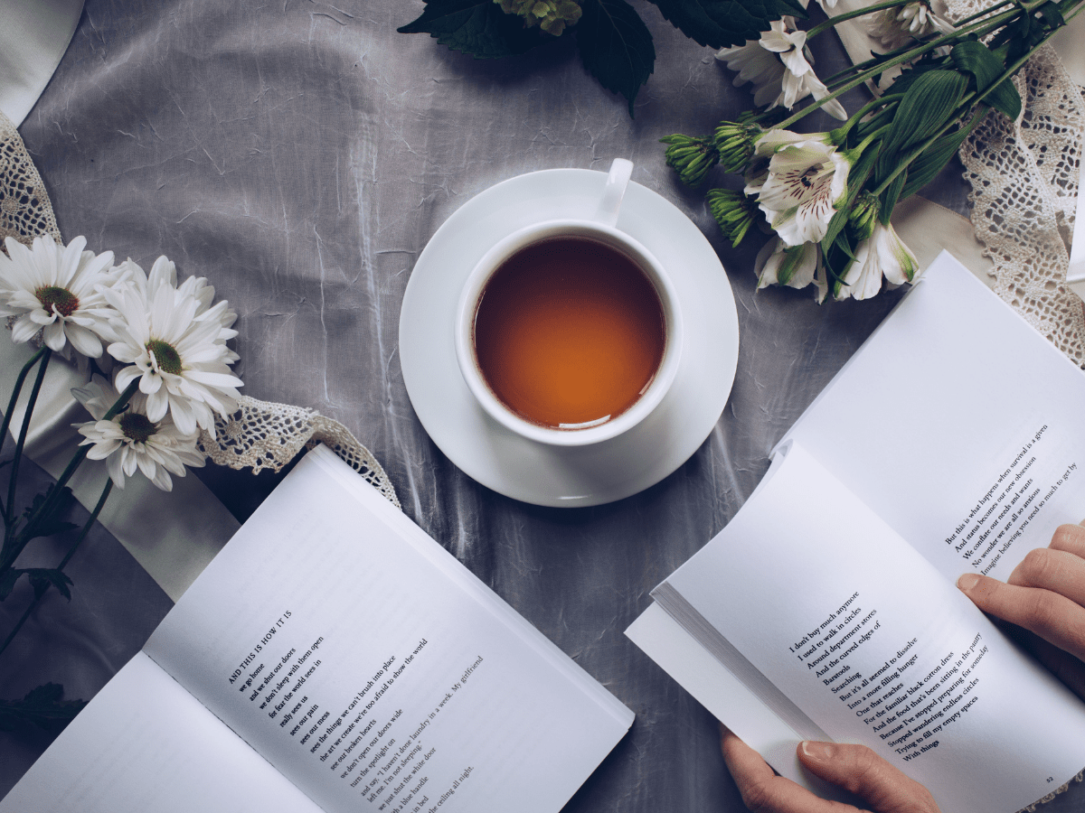 Cup of tea surrounded by open books