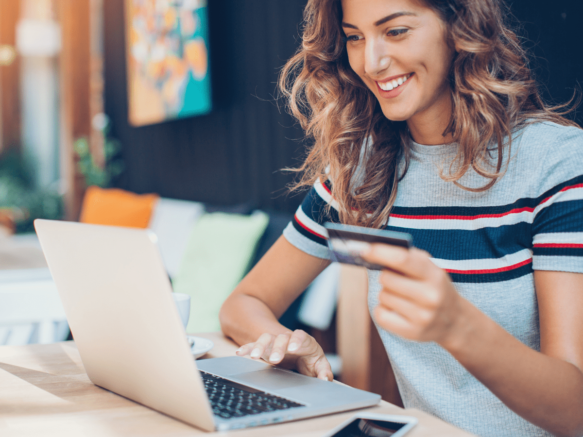 Woman holding a credit card, about to make an online purchase