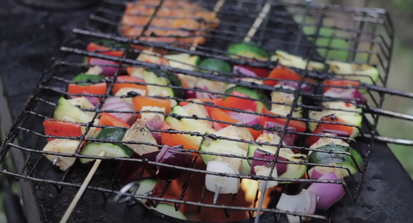 BBQ skewers/kebabs cooking on an Anevay portable wood burning outdoor Frontier Stove. Anevay Stoves