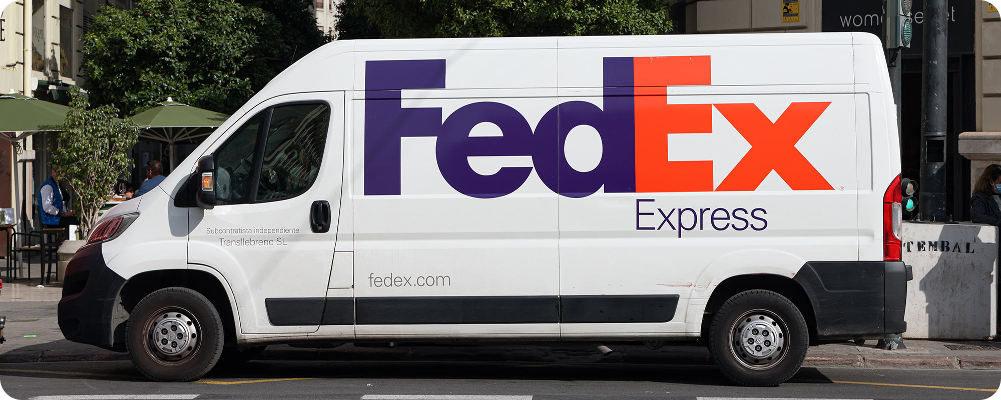 fedex van doing deliveries in the city