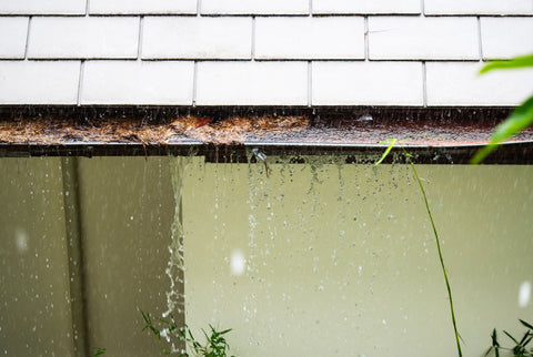 Gutter overflowing due to heavy rains and blockage