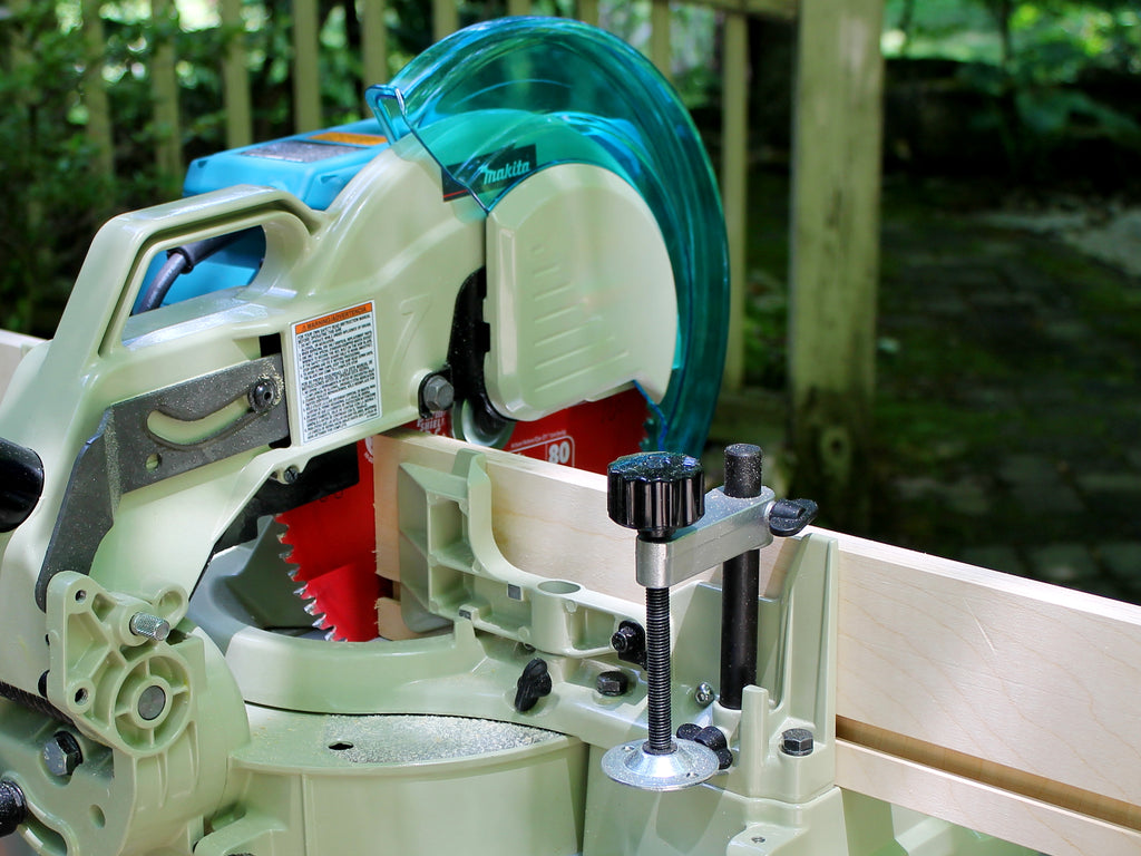 Rear quarter view of a zero-clearance miter saw fence, showing the WoodAnchor fixturing slots