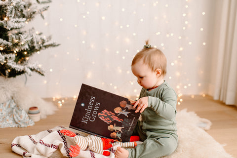 Toddler reading Kindness Grows book