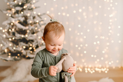 Toddler playing with an Organic Bunny stuffed animal