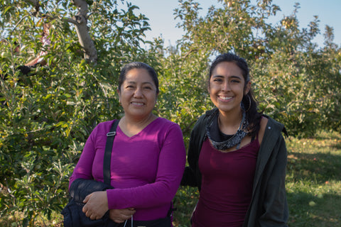 Maria, refugee from Mexico, and Camila, Fellowship Director, at an orchard on a Havenly trip