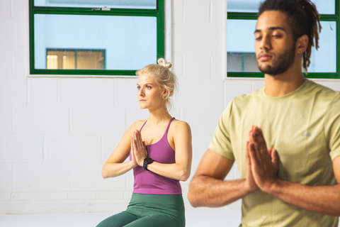 People in a yoga studio practising yoga, maintaining a good posture