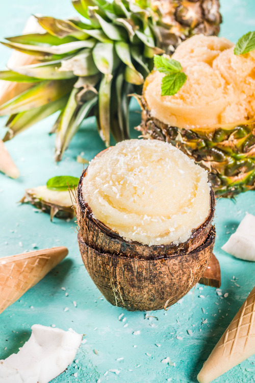 pineapple coconut ice cream scoop in a coconut shell