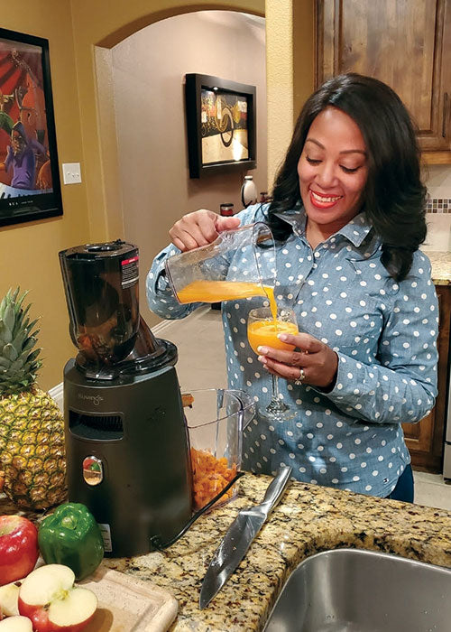 Kuvings Customer Review: Adrianne pours herself a glass of fresh juice.