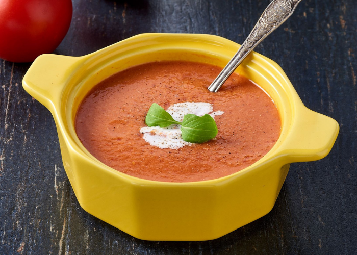 tomato soup in yellow bowl