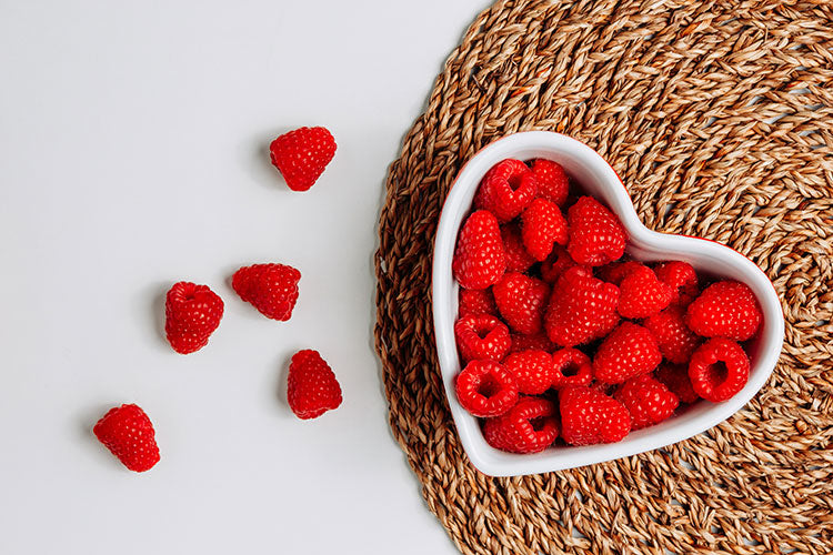 Kuvings red raspberries in a heart-shaped bowl