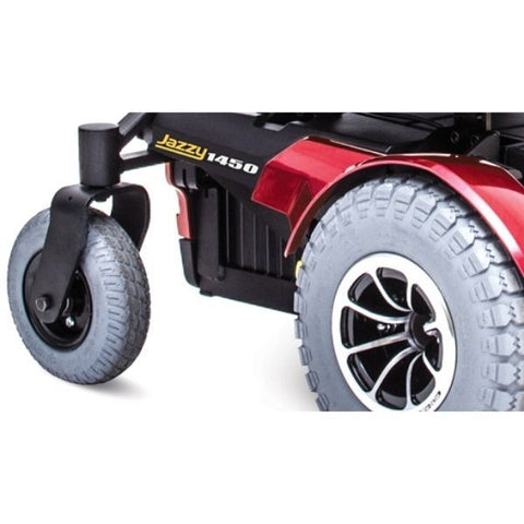 A Pride Jazzy 1450 Heavy Duty Power Chair with wheels, showcasing a side view.