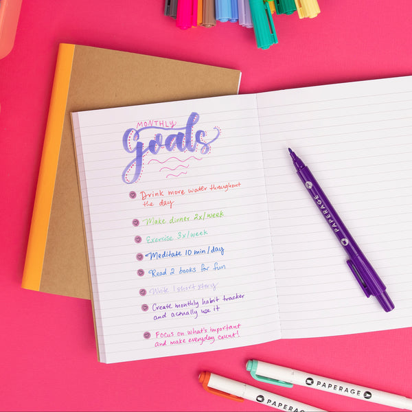 PAPERAGE Composition Notebook, Dual-tip Markers and Dual-tip highlighters with list of goals on hot pink background.