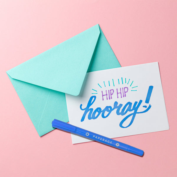 Green envelope, PAPERAGE marker and card with hand lettering on a pink background