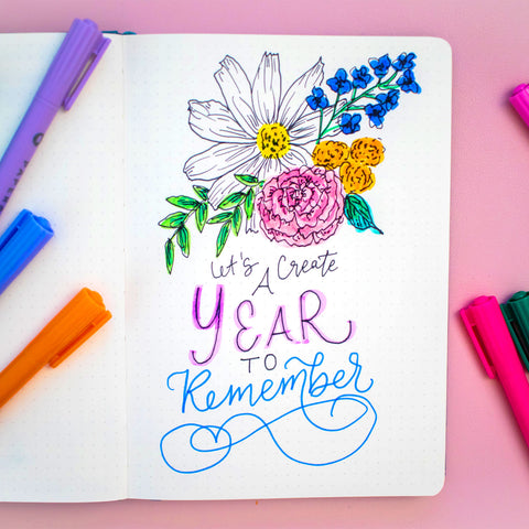 PAPERAGE Dotted Journal & Markers with hand-lettering that reads Let's Create A Year to Remember