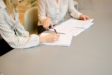 Two people with documents on their hands