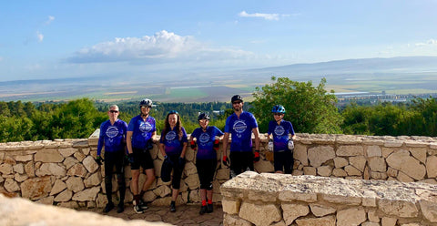 A group of cyclists wearing customized Cycle-Run cycling kits, featuring the team's logo and colors.