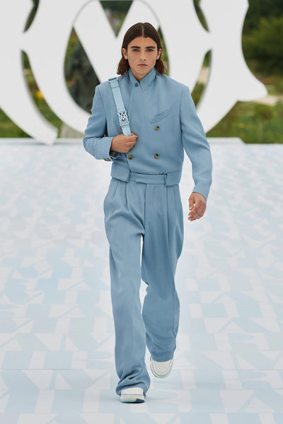 Model wears a blue suit at AMIRI's SS23 presentation for Paris Fashion Week