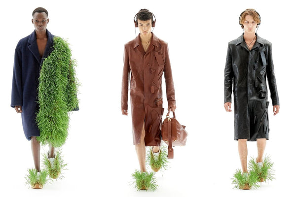 Models wear grass-covered coats and sneakers at Loewe's SS23 presentation for Paris Fashion Week 