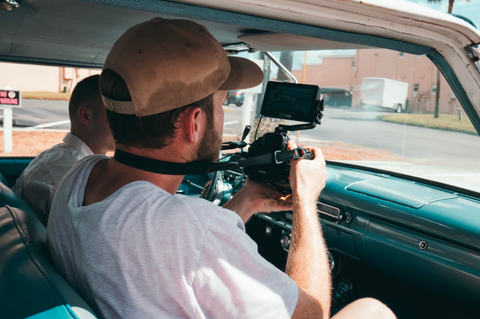 man taking photos with sweaty hat