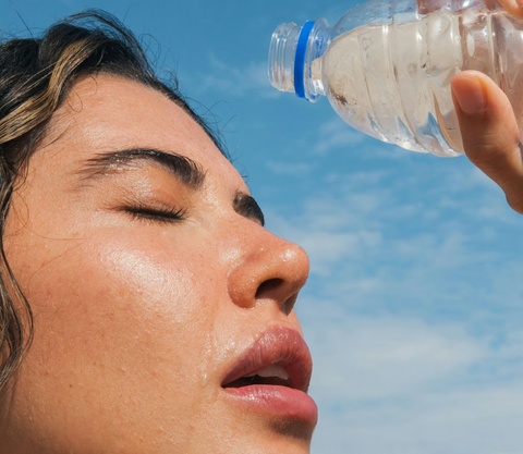 A woman sweating with a water bottle