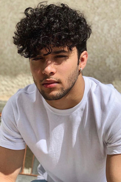 Guy with curly hair styled in curly undercut