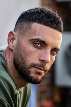 Tanned man with short hair cut in French Crop