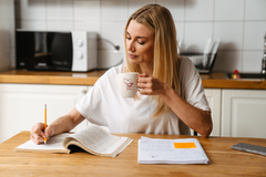 Woman studying and drinking coffee