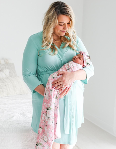 Mother and baby daughter in matching hospital outfits