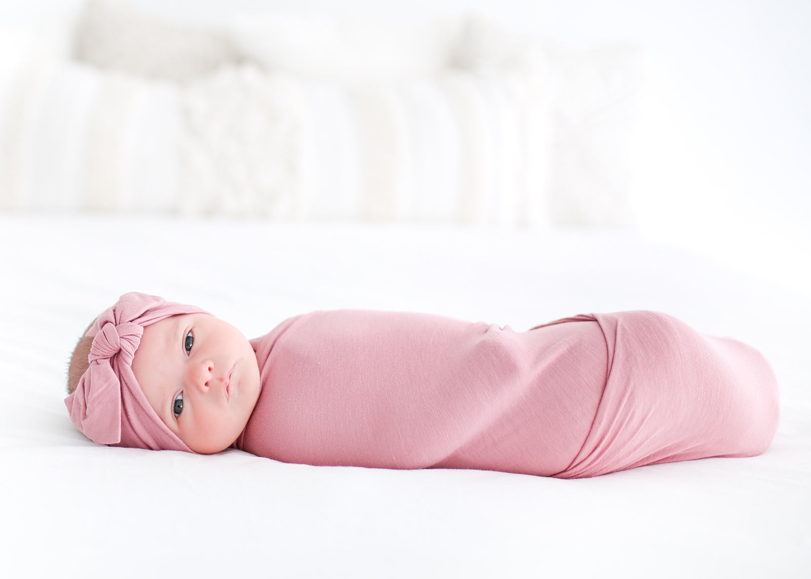 Baby Girl Swaddled in a Pink Swaddle and Headband Set