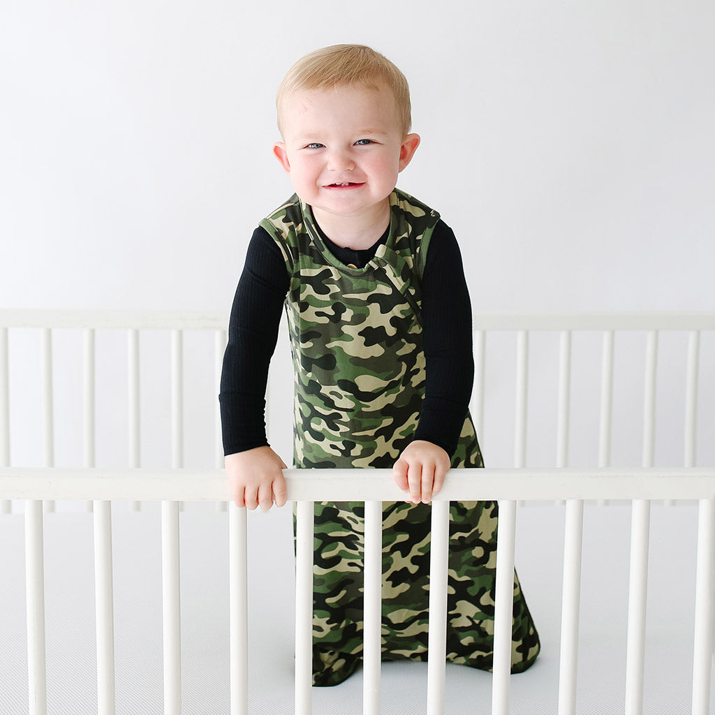 baby boy wearing camo print baby sleeping bag with long sleeves