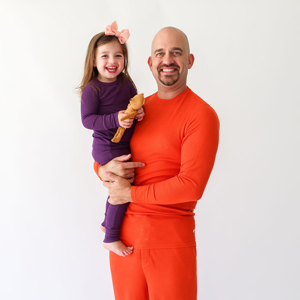 Man with daughter in waffle pajamas