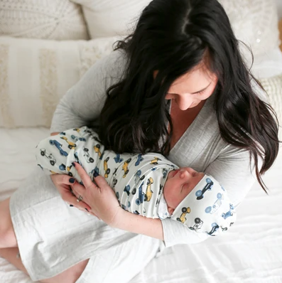 baby boy blanket with car pattern in mom's arms