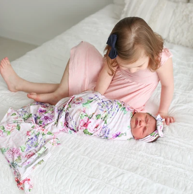 baby girl blanket with floral pattern on bed