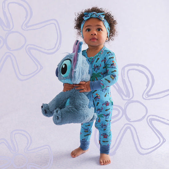 toddler holding Disney Lilo plushie wearing matching onesie