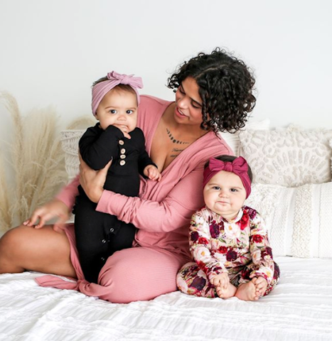 Woman on bed with two baby girls