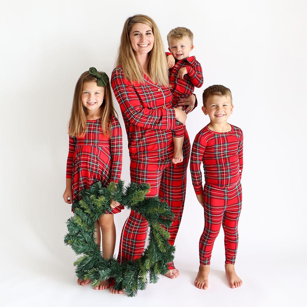 Family in vintage tartan Christmas pajamas with wreath