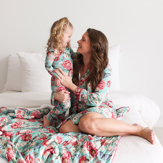 mom and daughter in matching floral print pajamas