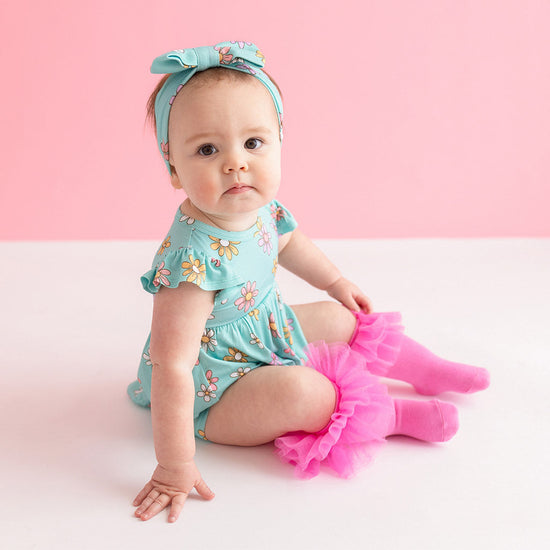 baby in teal floral print dress
