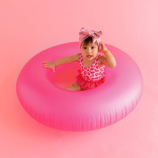 Baby in pink float tube 
