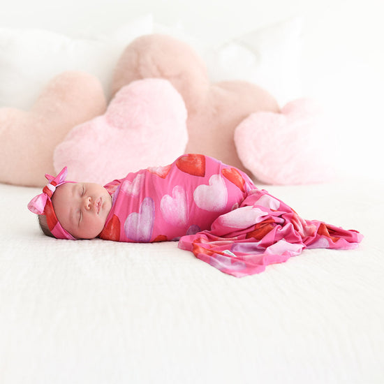 Baby sleeping in heart swaddle