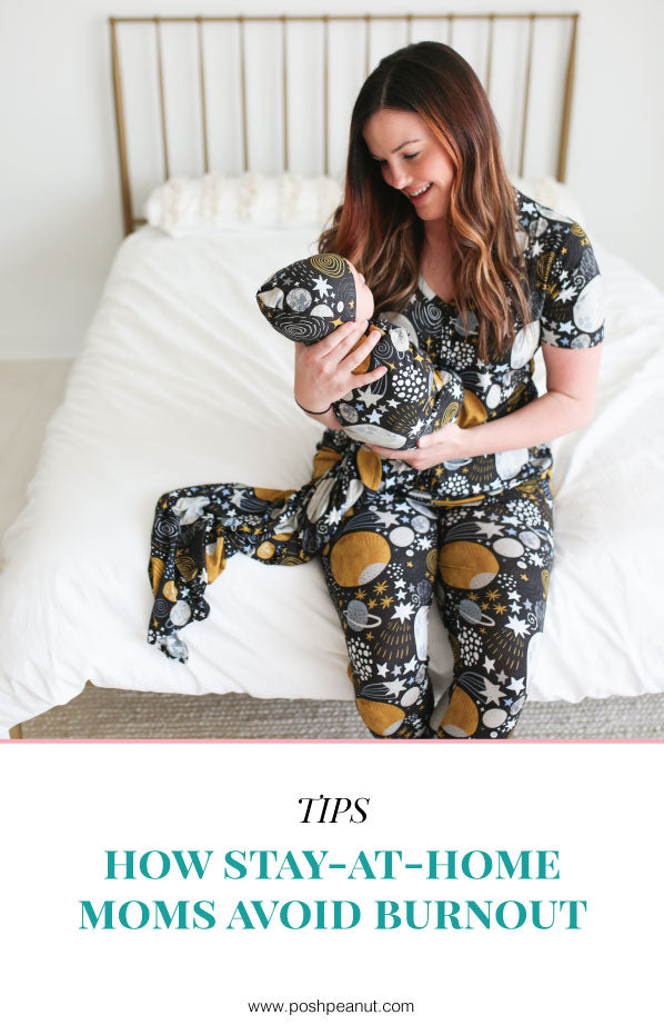 mom and baby in pajamas sets with space print on bed